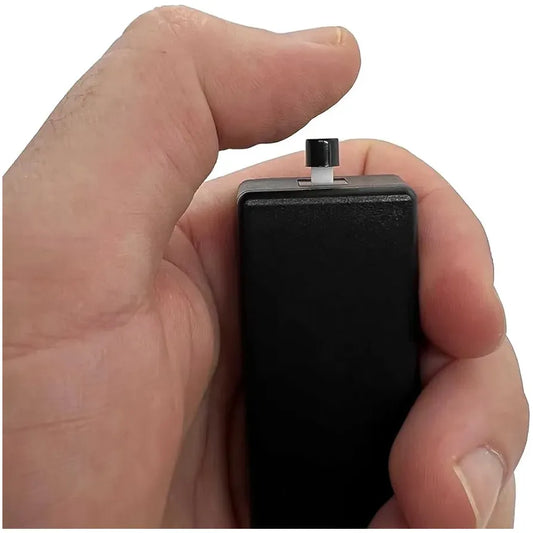 Black Vox voice activated recorder held in hand showing compact pocket-sized design with USB connector